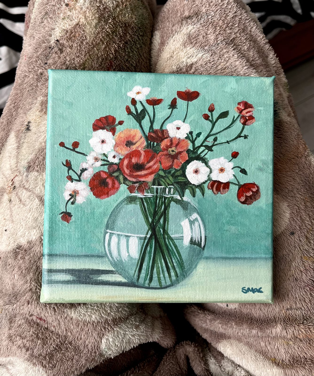 The Gathered Blooms canvas laid flat, showing the whole painting and the signature