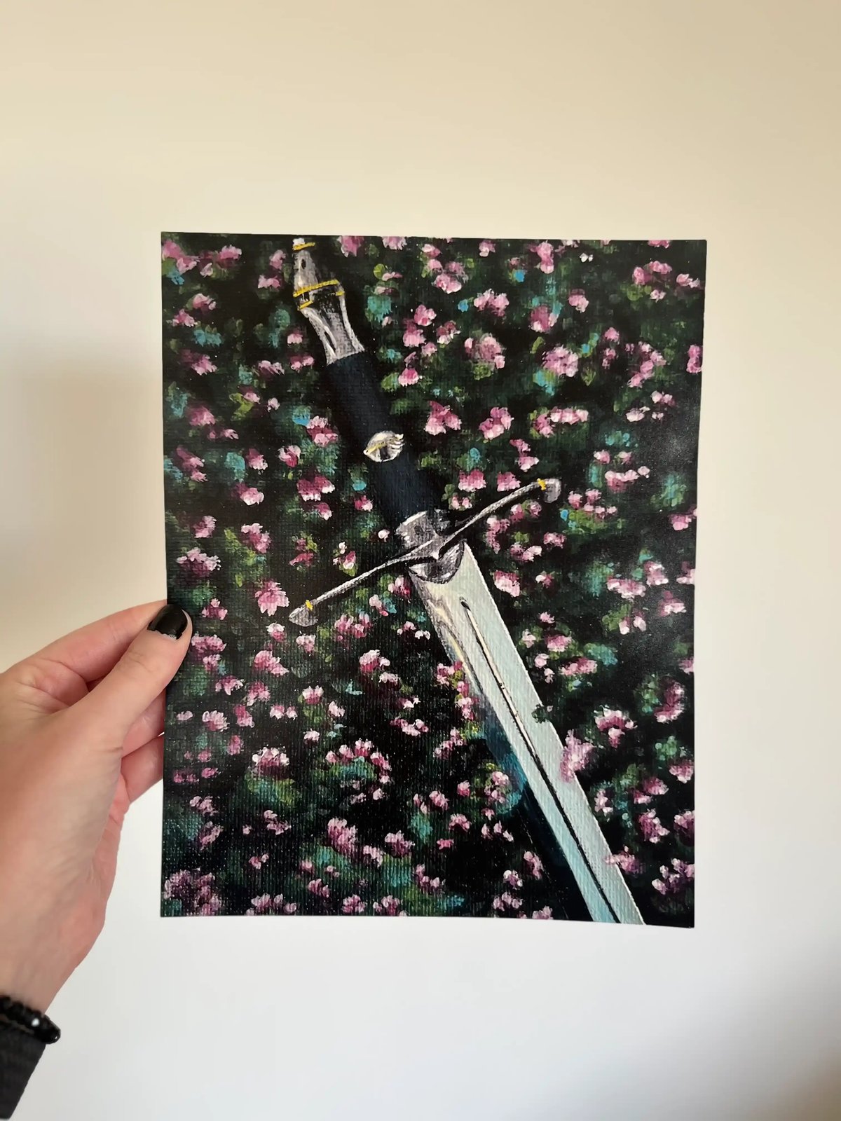 The largest Lost Sword print, 10 by 8 inches, held up against a plain wall