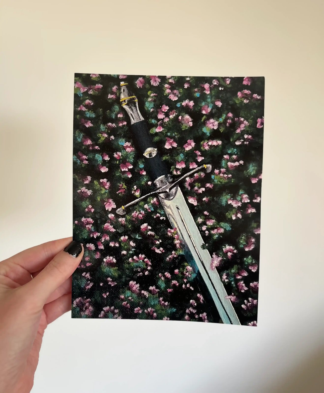 The 8 by 6 inch Lost Sword print held in one hand
