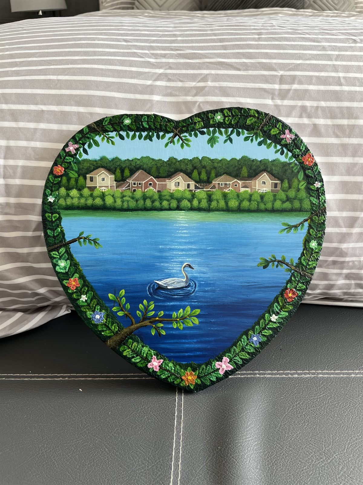Peace stood against a pillow, showing the full shape of the heart canvas