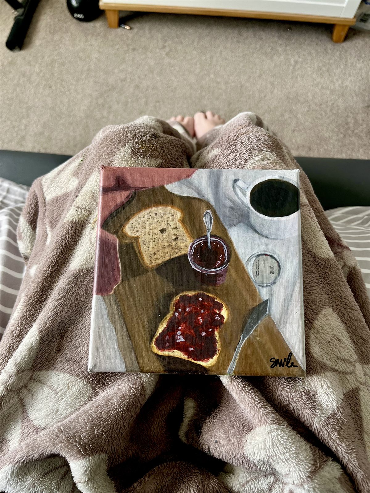 The Strawberry Jam canvas resting on a lap, showing how it looks held in a room