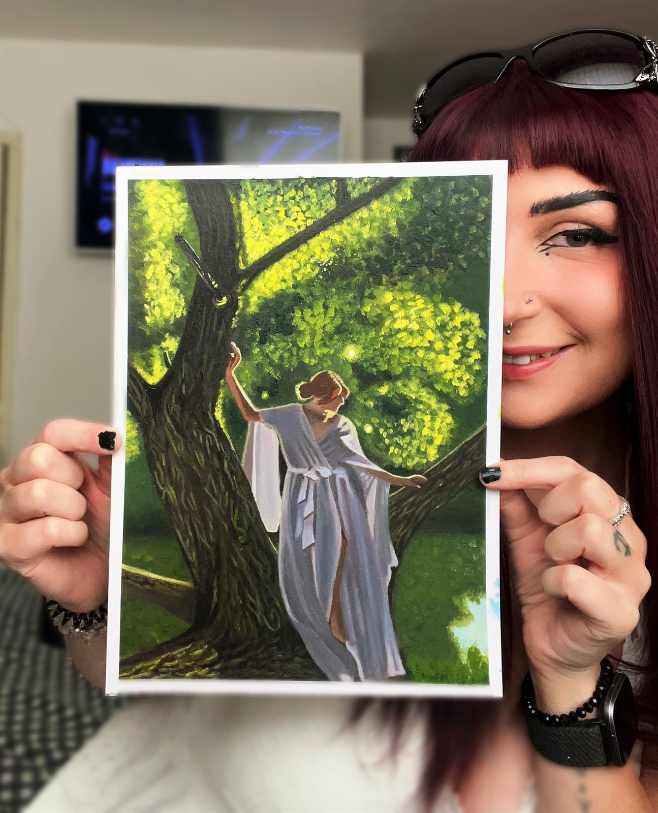 Sylvan held up beside Sarah&rsquo;s face, showing how big the painting is